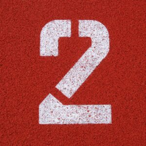 2 on a red background for 2 reasons not to start a podcast